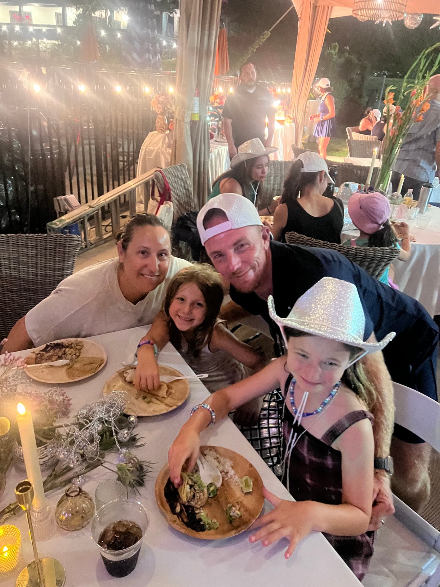 Families at a club dinner under the lights